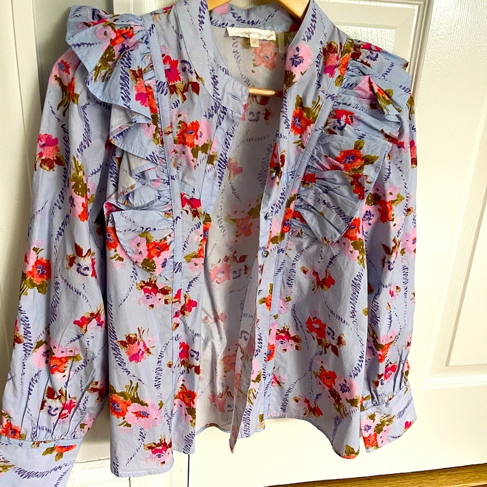 button down with ruffle shoulders.